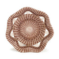 Woven basket with concentric circular pattern on a white background