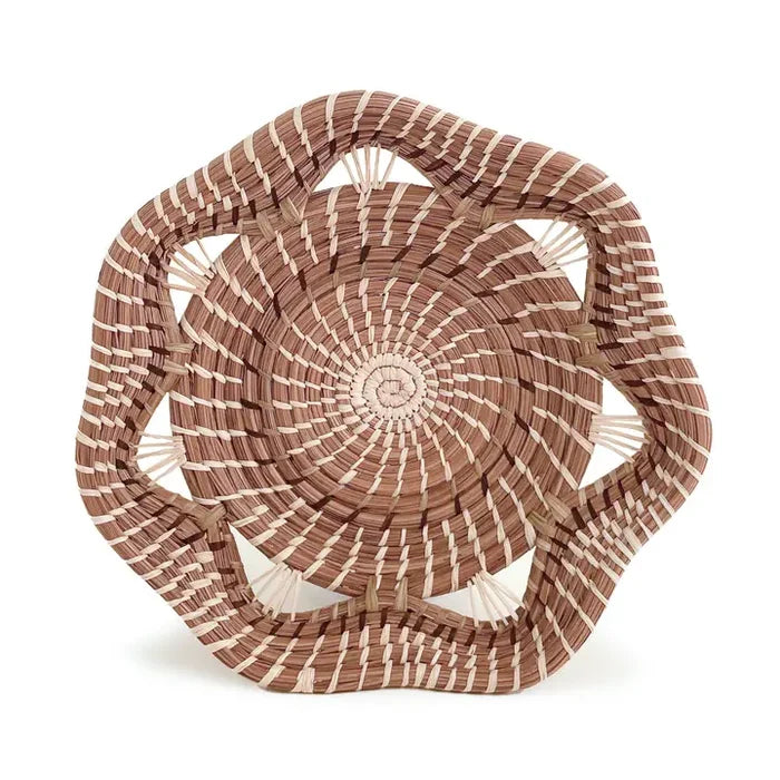 Woven basket with concentric circular pattern on a white background
