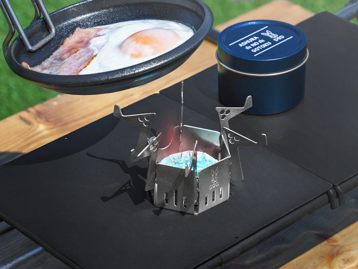 Ashura Mini Stove: silver hexagonal camping stove with wing-like supports