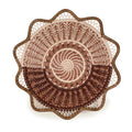 Decorative woven basket with intricate patterns on a white background