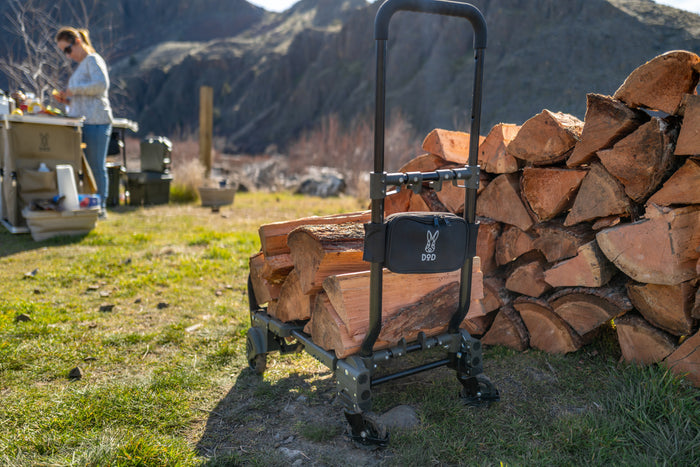 Camp Barrow black metal firewood cart with d90 logo pouch on handle