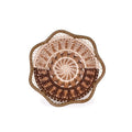 Decorative woven plate with a spiral pattern on a white background