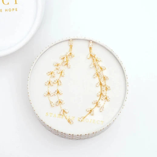 Gold leaf earrings on a white box with 'Starfish Project' branding.