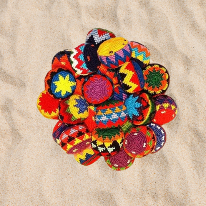 A group of footbags in the sand