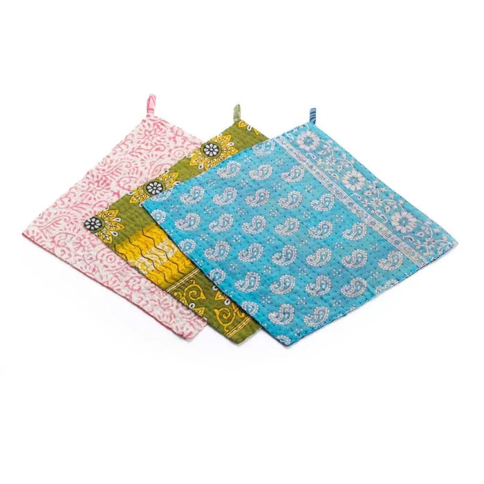 Set of four colorful patterned dishcloths on a white background