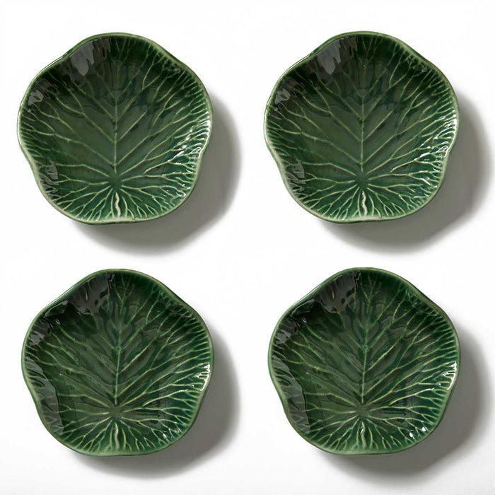 Four green ceramic leaf-patterned plates on a white background