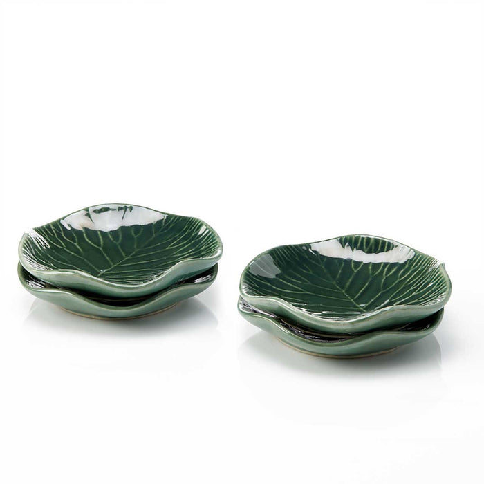 Set of green ceramic leaf-shaped plates on a white background