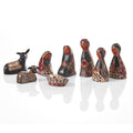 A nativity set with various figures, carved and painted with traditional Indonesian patterns in black, brown, and white tones.