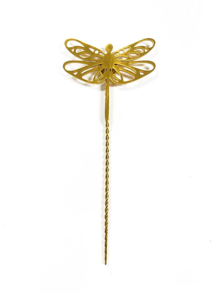 Gold dragonfly-shaped plant stake on a white background