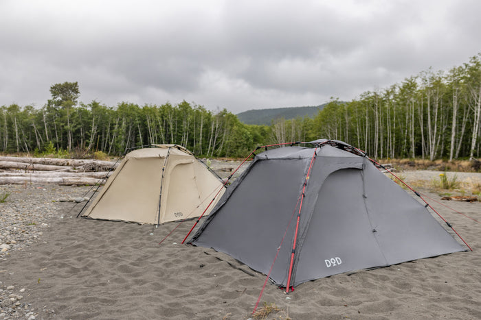 Gray Moto 1Pull tent with red guy lines and beige companion tent on sand