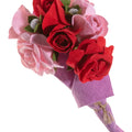 Bouquet of pink and red artificial flowers on a white background