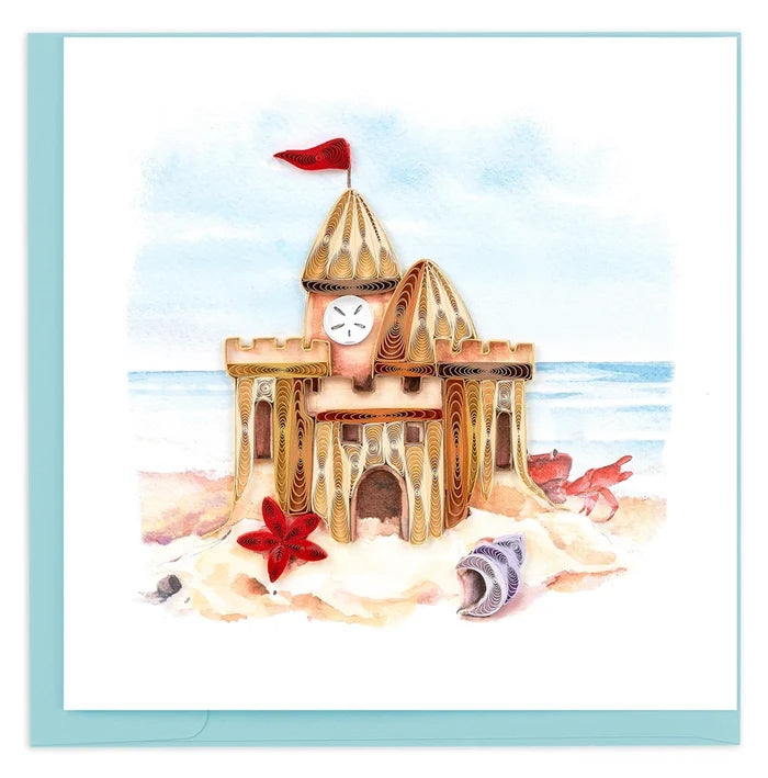 Illustration of a sandcastle with seashells and a starfish on a beach on a quilled card.
