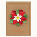 A brown kraft paper holiday card with a 3D poinsettia flower made from layered paper petals in red, white, and green, with 'Happy Holidays' written in red script at the bottom.
