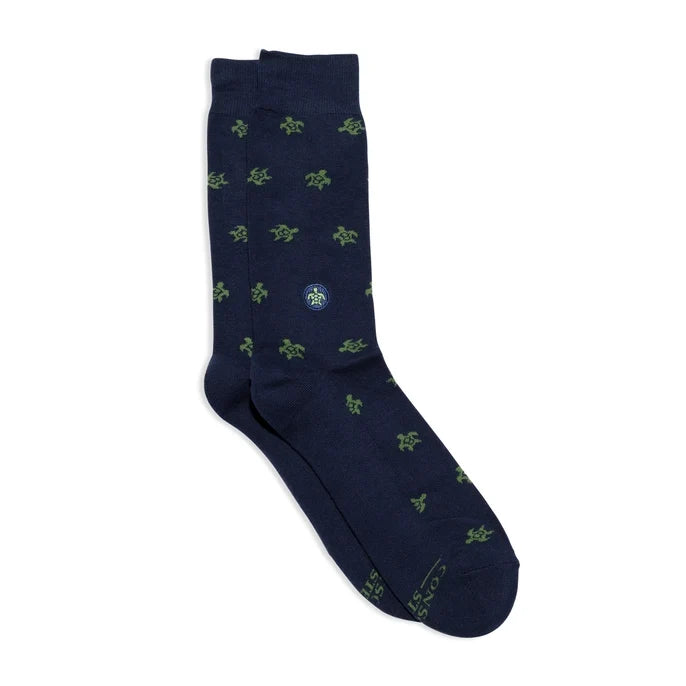 Navy sock with green turtle pattern on a white background