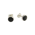 A pair of silver stud earrings with round black inlay discs, shown from both front and side angles on a plain white background.
